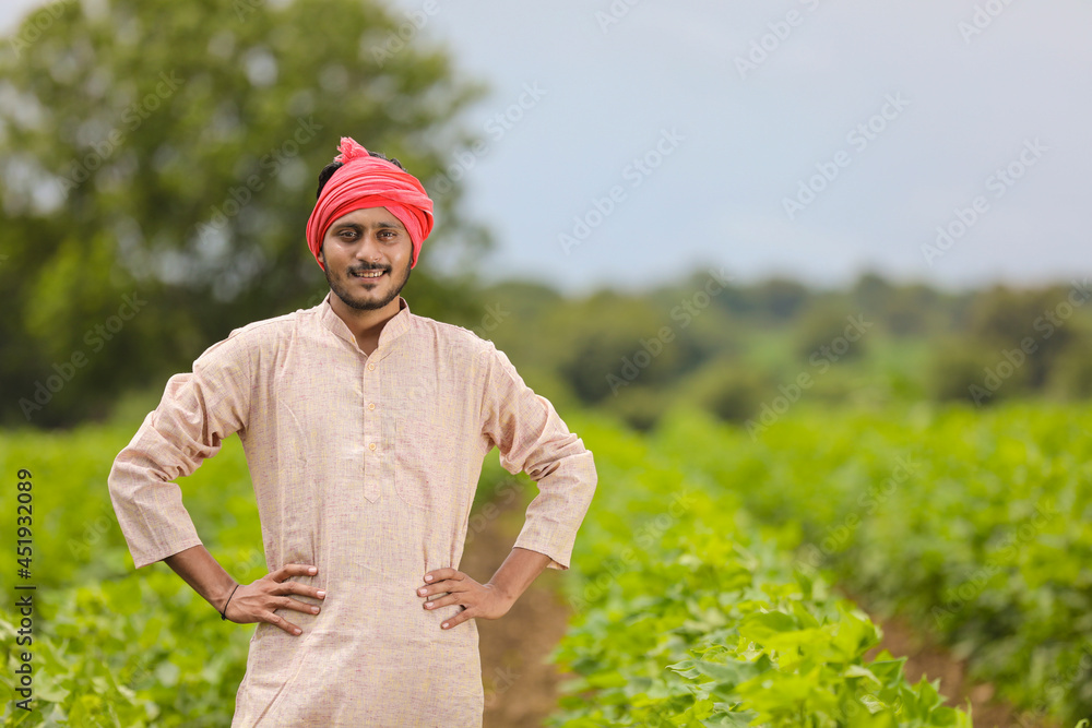 Young indian farmer standing at agriculture field. Young indian farmer standing at agriculture field.