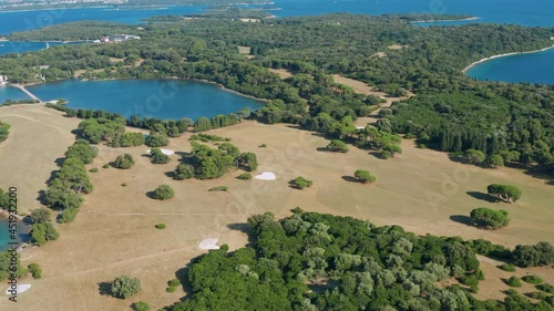 Aerial shot slowly circling around the island of Brijuni, Croatia on a bright day. photo