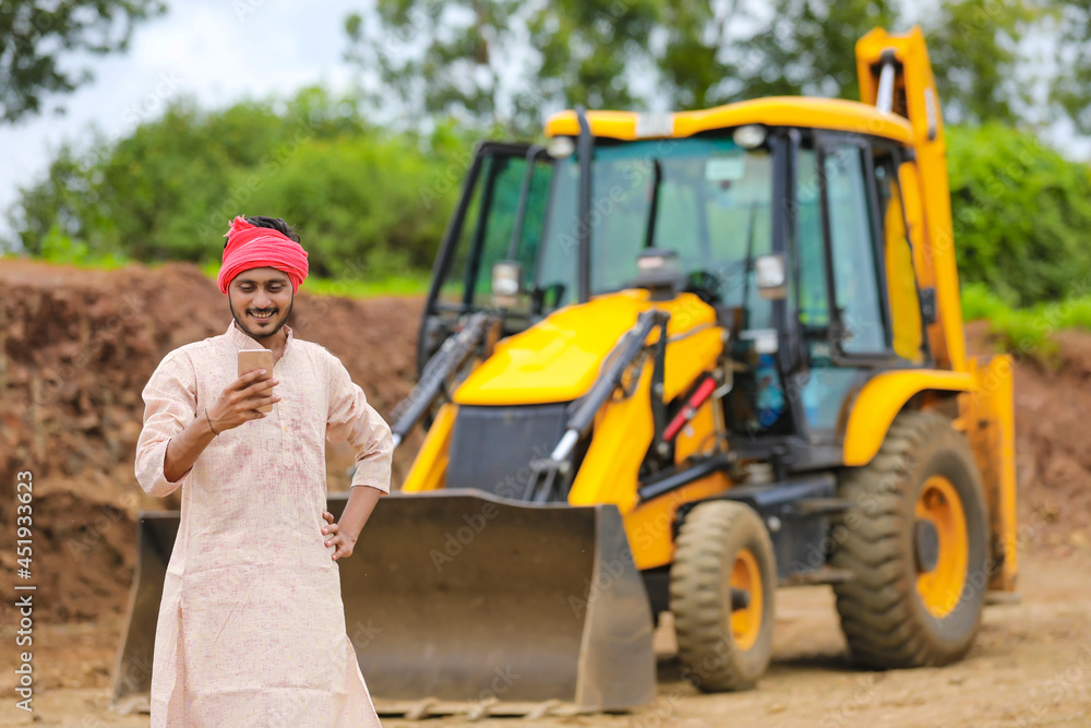 Indian farmer using smartphone at his field Indian farmer using smartphone at his field