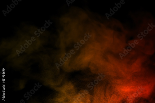 close-up of floating colorful steam smoke spray isolated on a black background