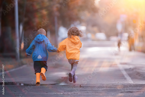 children run in the yellow autumn park rain / fun walk autumn seasonal landscape weather wet © kichigin19