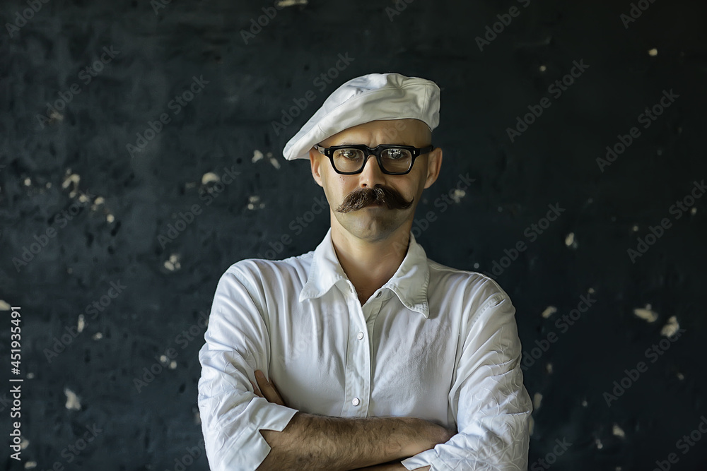 Portrait of a brutal mustachioed cook, in the profession uniform, white cap. glasses man Portrait of a brutal mustachioed cook, in the profession uniform, white cap. glasses man
