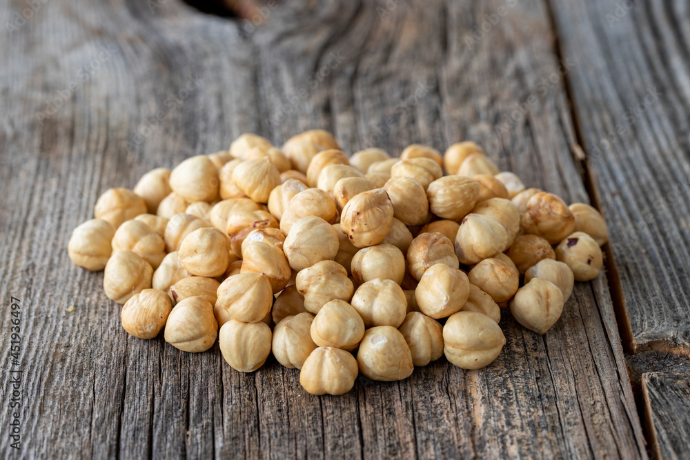 Roasted hazelnut. Hazelnuts on wood background. Bulk Hazelnut kernels Roasted hazelnut. Hazelnuts on wood background. Bulk Hazelnut kernels