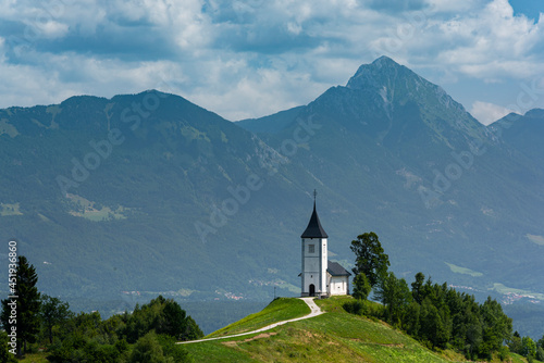 Jamnik Church of Saint Primoz with Alps Mountains in Background in Slovenia