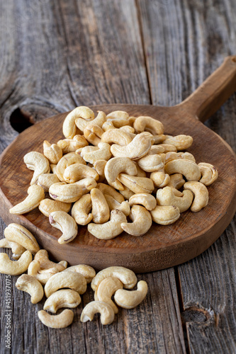 Roasted Cashews. Cashew nuts on wood background. Bulk Cashews.