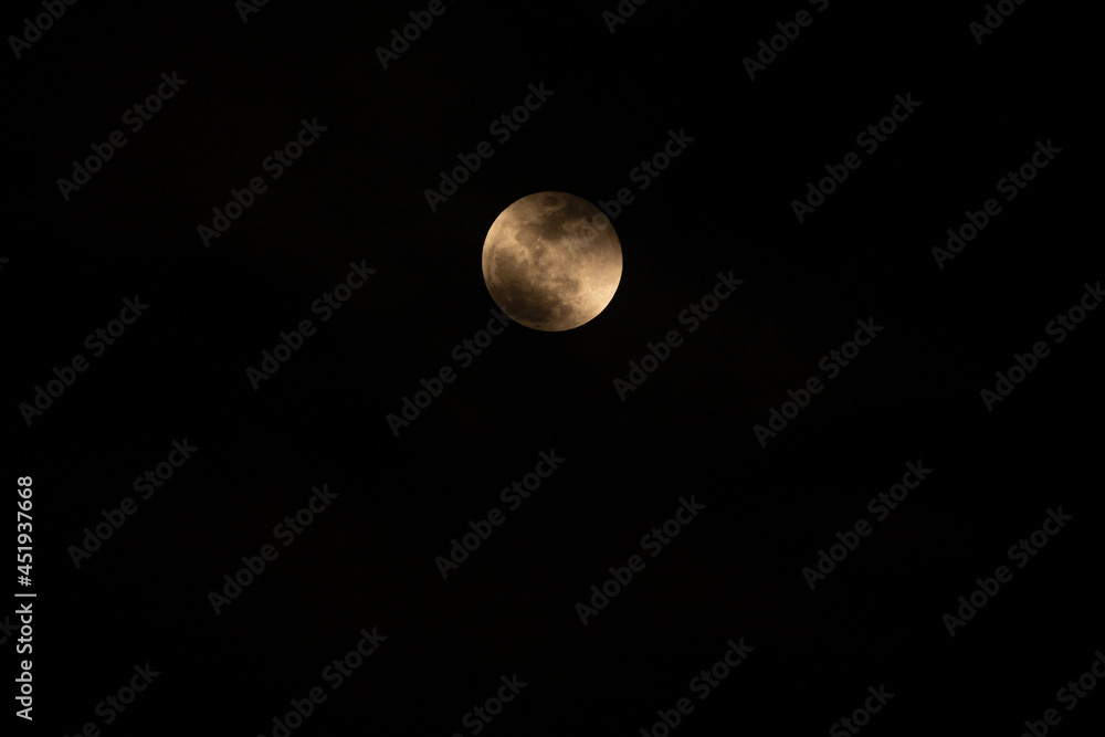 Moonlight yellow gold in the night time.Night landscape and space background.The moon cloudy in dark sky at midnight.Beautiful fantasy nature landscape at night scene background.