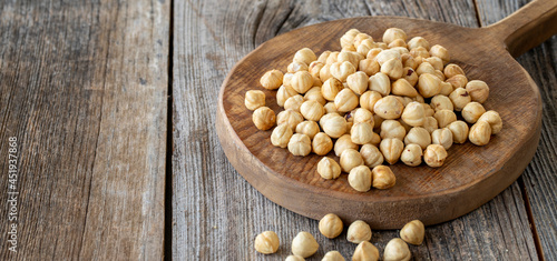 Roasted hazelnut. Hazelnut nuts on wood background. Bulk Hazelnut kernels. Copy Space