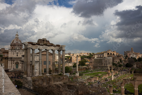 Top view of the Roman Forum against a dramatic sky. Ancient architecture and the urban landscape of historical Rome.
