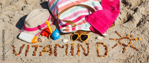 Inscription vitamin D, accessories for relax and childrens playing on sand at beach. Prevention of vitamin D deficiency