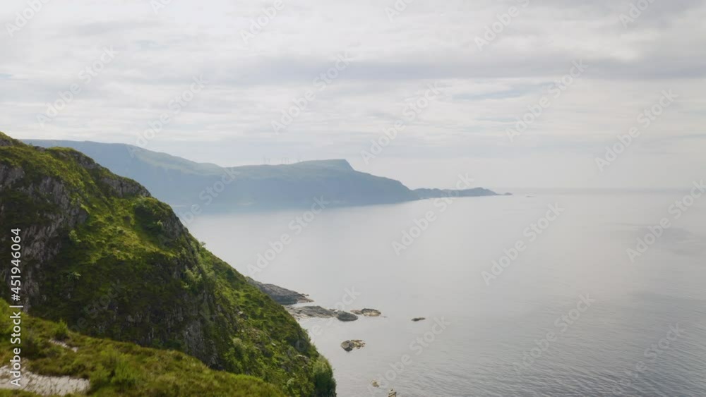 Rugged Mountain In The Town Of Maloy, Vagsoy Island, Norway Overlooking Calm Lake On A Foggy Weather. aerial Rugged Mountain In The Town Of Maloy, Vagsoy Island, Norway Overlooking Calm Lake On A Foggy Weather. aerial