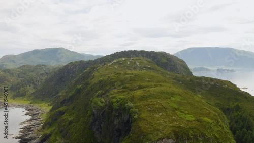 Green Rocky Mountain In The Island Of Vagsoy At The Coast Of Misty Fjord In Maaloy, Norway. aerial photo