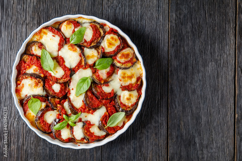 Tableau sur toile eggplant parmigiana in a baking dish, top view