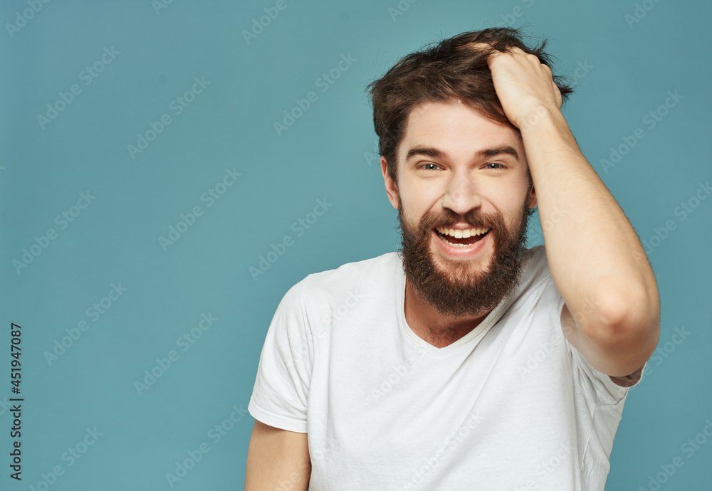 emotional man in a white t-shirt hand gestures anger blue background emotional man in a white t-shirt hand gestures anger blue background