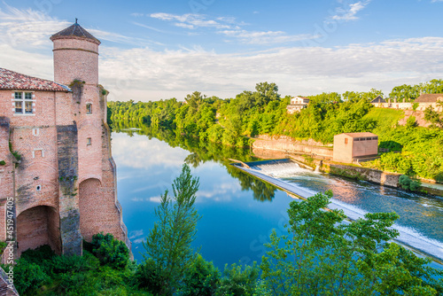 Morning view at the Tarn river with tower of Church of Saint Michel in Gaillac, France photo