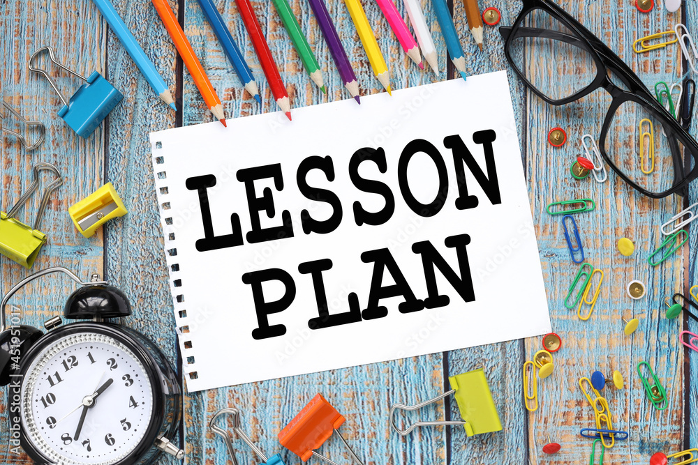 Lesson Plan. multicolored stationery on a blue wooden table. pencils ...