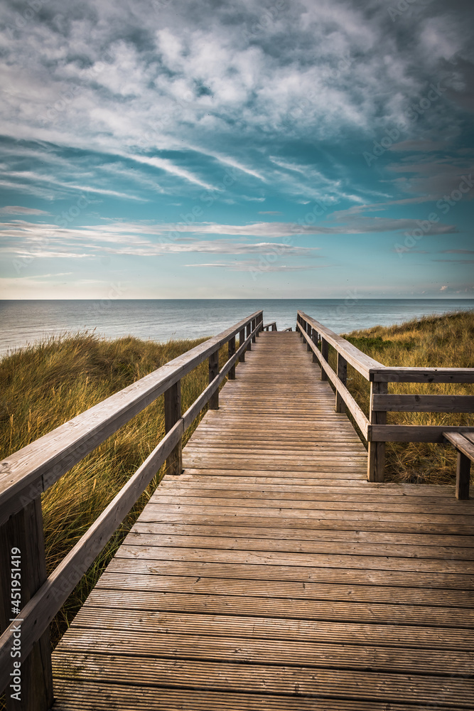 A wooden walking path in Wenningstedt on the german island of Sylt, North Sea, vertical