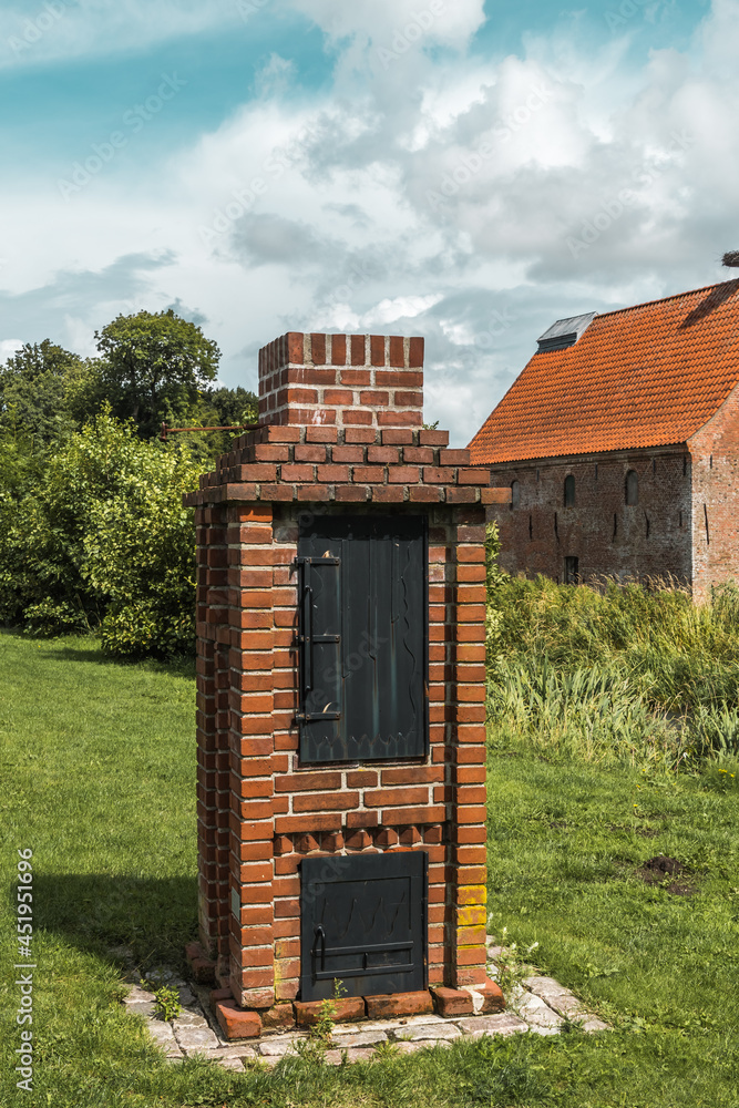Smoker oven made of bricks on a meadow