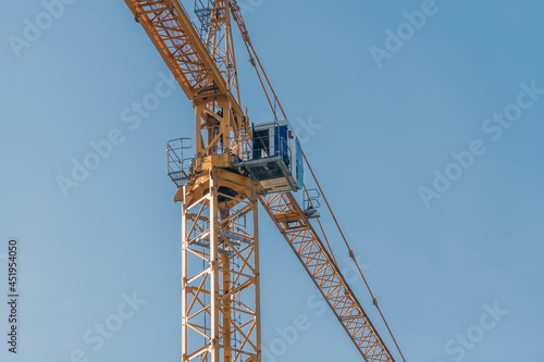 Wallpaper Mural Yellow tower construction crane against blue sky background Torontodigital.ca