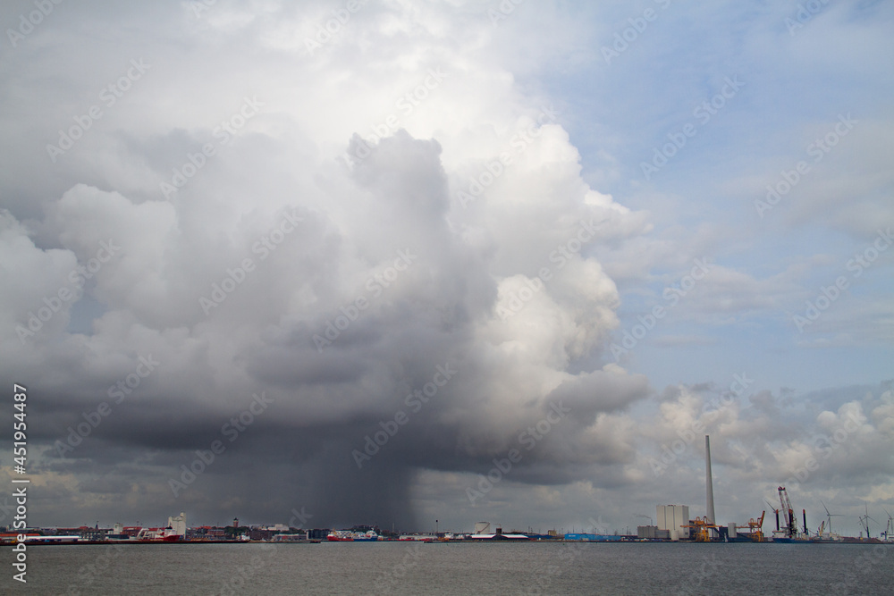 Raincloud, a giant cumulonimbus, and rain above Skagen in Jutland, Denmark, seen from the Skagerrak