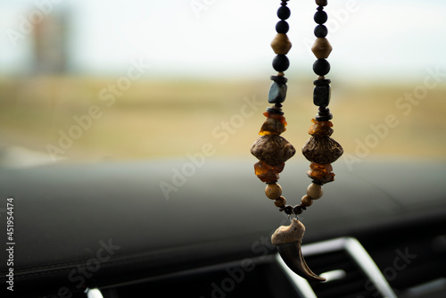 Charm beads made of natural stones (jasper, obsidian, amber) and a bear's claw. High quality photo