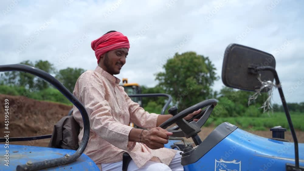 Indian farmer working with tractor at farm. Indian farmer working with tractor at farm.