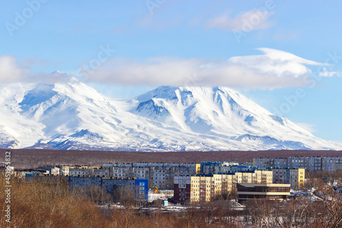 The peaks of volcanoes against the background of the autumn Petropavlovsk Kamchatsky. Autumn vacation in Russia.