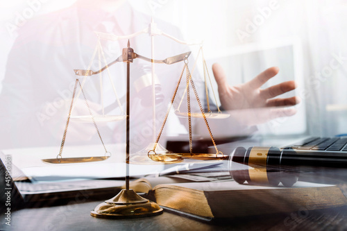 justice and law concept.Male judge in a courtroom on wooden table and Counselor or Male lawyer working in office. Legal law, advice and justice concept.