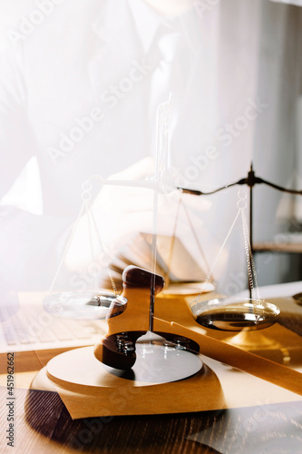 Business and lawyers discussing contract papers with brass scale on desk in office. Law, legal services, advice, justice and law concept picture with film grain effect © ARMMY PICCA