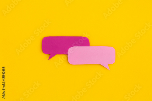 Obraz na płótnie Paper speech bubbles on a yellow background. Top view with copy space. Flat lay. w salonie