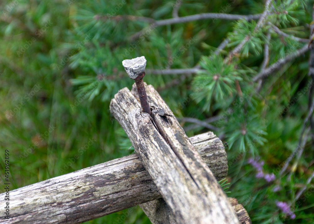 an old wooden structure with a rusty iron screw