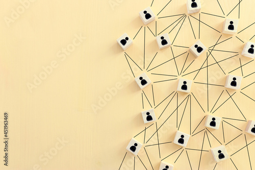 Foto image of tangram blocks with people icons over wooden table ,human resources and