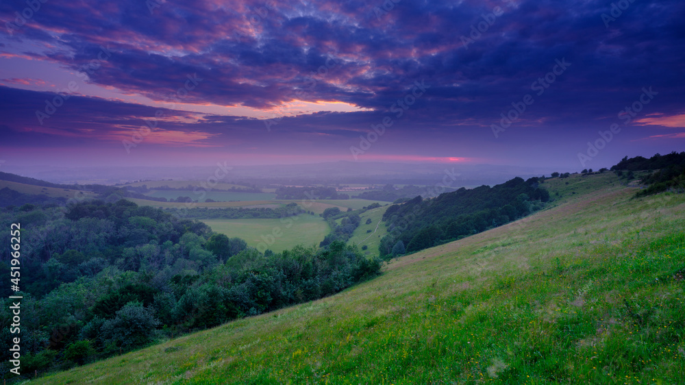 Summer sunset over the Meon Valley towards Beacon Hill from Old Winchester Hill, South Downs National Park, Hampshire, UK