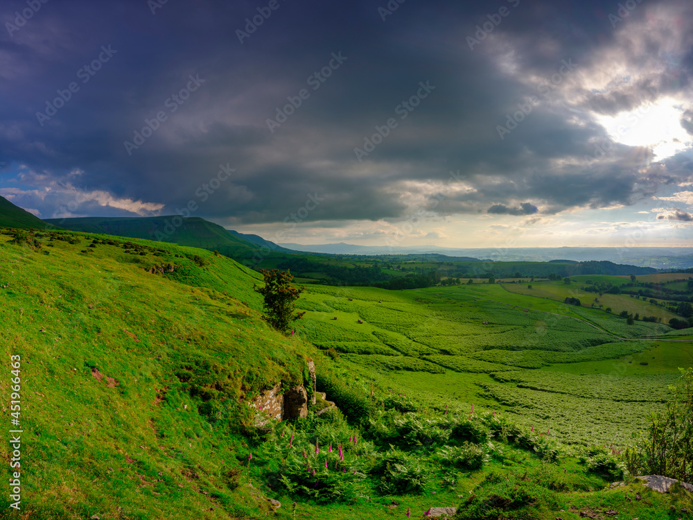 Fototapeta premium Golden hour sunlight on the view from just below Gospel Pass over the northern foothills of the Black Mountains including the ridge of Lord Hereford's Knob, Wales