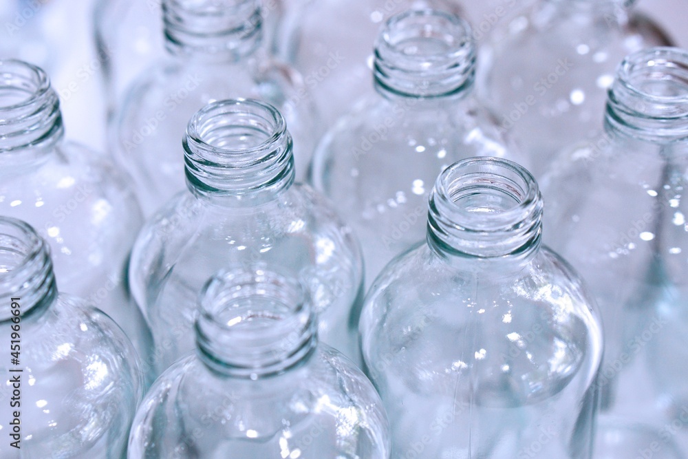 Close up of clean empty glass bottles for packing and contain. Close up of clean empty glass bottles for packing and contain.