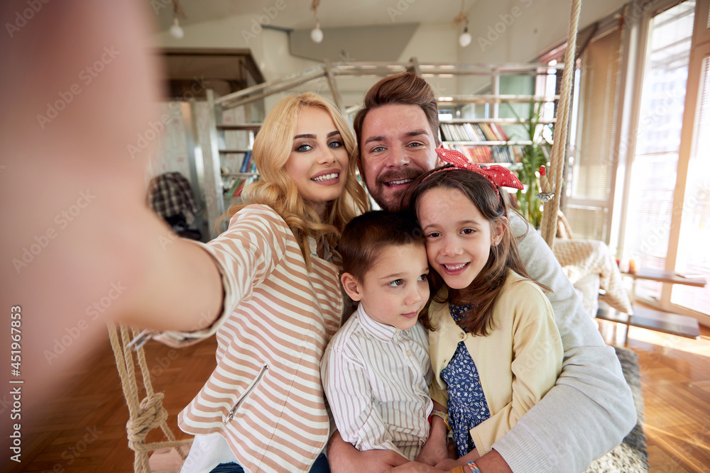 A happy family taking a selfie at home together. Family, leisure, together A happy family taking a selfie at home together. Family, leisure, together
