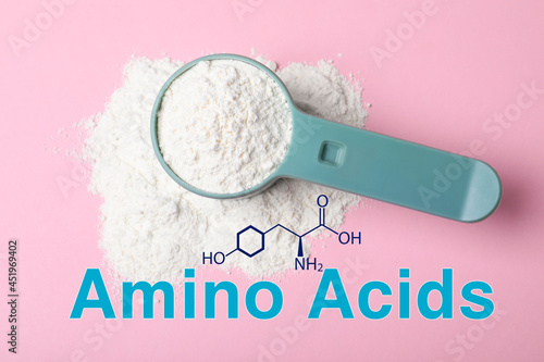 Measuring scoop of amino acids powder on pink background, top view
