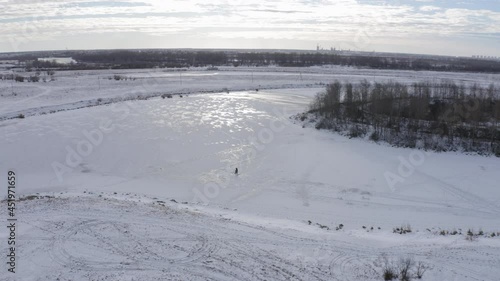 Wallpaper Mural A fisherman fishing in winter time on ice covered river Torontodigital.ca
