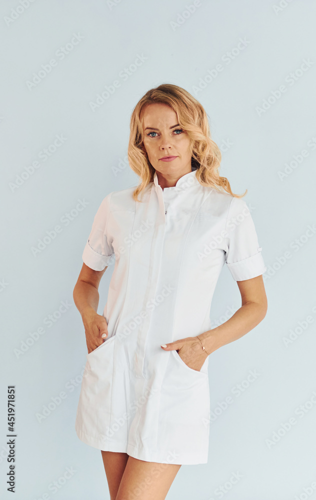 Professional occupation. Young female doctor in uniform is indoors Professional occupation. Young female doctor in uniform is indoors