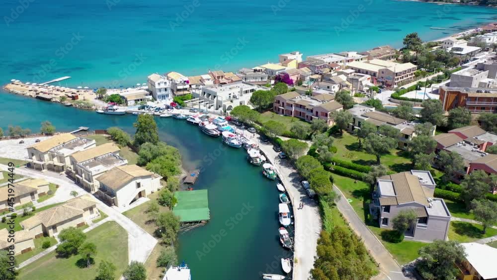 Water channel between Moraitika and Messonghi villages, Corfu Island in Greece, view with Messonghi Beach holiday resort on left, 4k drone footage
