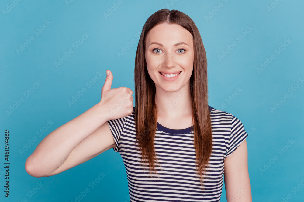 Portrait of positive reliable lady raise thumb up shiny white smile on blue background Portrait of positive reliable lady raise thumb up shiny white smile on blue background