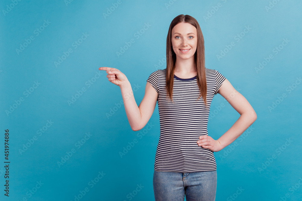 Portrait of cute adorable girl indicate forefinger empty space white smile on blue background Portrait of cute adorable girl indicate forefinger empty space white smile on blue background