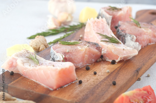 raw fresh fish on a chopping board for preparing for cooking on table ,