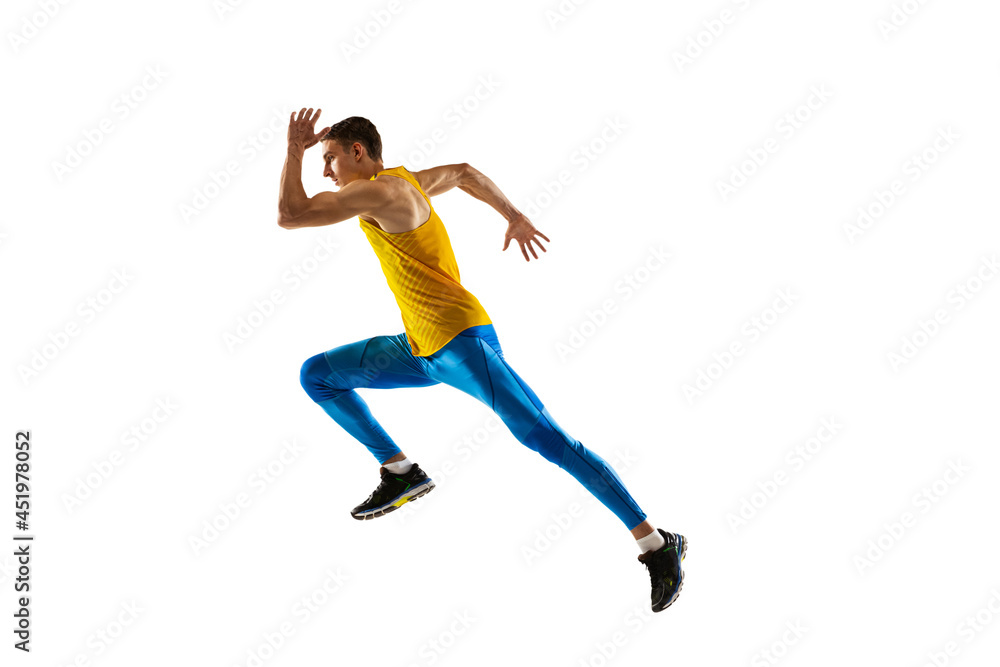 Profile view of Caucasian professional male athlete, runner training isolated on white studio background. Concept of action, motion, youth, healthy lifestyle.