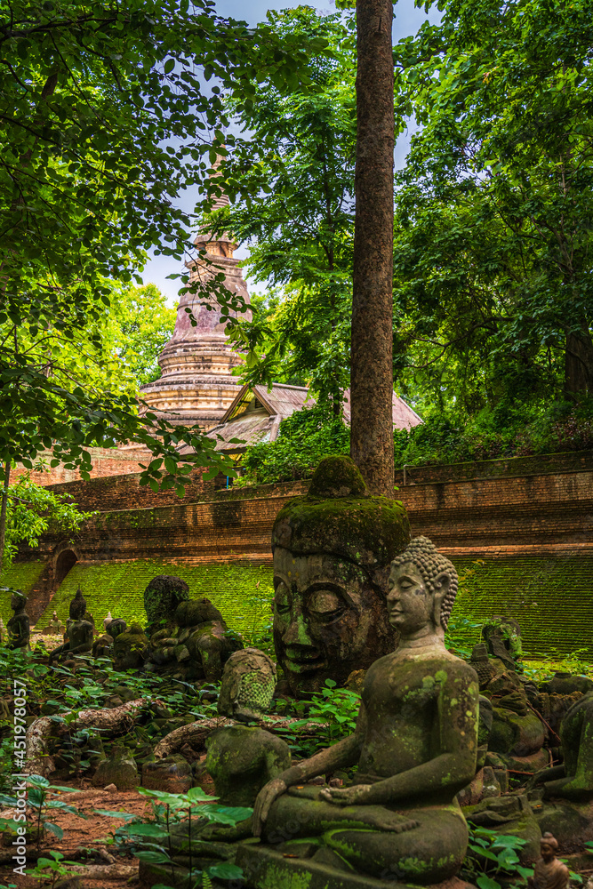 Ancient buddha figures Wat Umong Suan Puthatham is a Buddhist temple in the historic centre and is a Buddhist temple is a major tourist attraction with green forest nature in Chiang Mai,Thailand. Ancient buddha figures Wat Umong Suan Puthatham is a Buddhist temple in the historic centre and is a Buddhist temple is a major tourist attraction with green forest nature in Chiang Mai,Thailand.