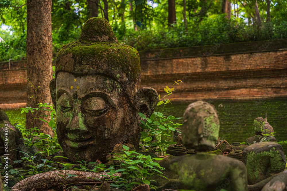 Ancient buddha figures Wat Umong Suan Puthatham is a Buddhist temple in the historic centre and is a Buddhist temple is a major tourist attraction with green forest nature in Chiang Mai,Thailand.