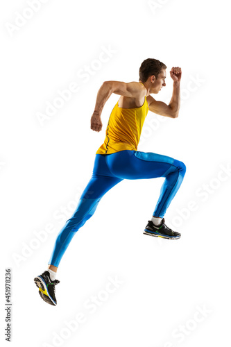 Back view of Caucasian professional male athlete, runner training isolated on white studio background. Muscular, sportive man. Concept of action, motion, youth, healthy lifestyle.