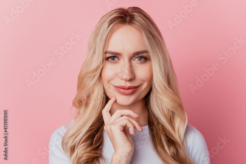 Portrait of cheerful charming girl finger cheek smart look camera on pink background