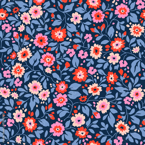 Vintage floral background. Floral pattern with small colorful flowers on a blue background. Seamless pattern for design and fashion prints. Ditsy style. Stock vector illustration.