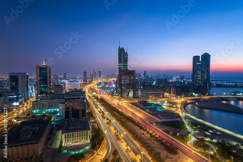 Aerial view of Manama skyline after sunset and newly constructed modern buildings with beautiful lights. photo