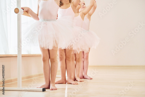 Close up view. Little ballerinas preparing for performance by practicing dance moves